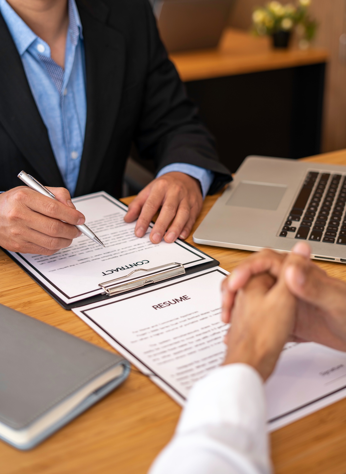 Human resources manager conducting job interview with applicant in the office, Candidate with resume